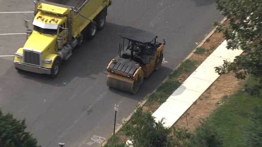 A road roller sits next to a dump truck near a Delaware County, Pennsylvania, middle school.