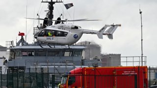 A French rescue helicopter lands close to a rescue vessel
