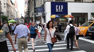 Pedestrians pass in front of a GAP store in New York.