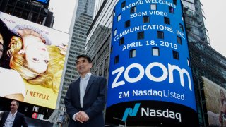 Zoom founder Eric Yuan poses in front of the Nasdaq building as the screen shows the logo of the video-conferencing software company Zoom after the opening bell ceremony on April 18, 2019 in New York City.