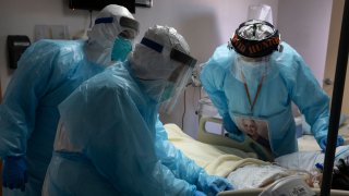 Medical staff examine a patient