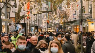 People with face masks walk in the city center of Cologne, Germany, on November 21, 2020.