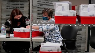 Lehigh County workers count ballots as vote counting in the general election continues, Thursday, Nov. 5, 2020, in Allentown, Pennsylvania. Joe Biden took the lead in Pennsylvania early Friday morning.