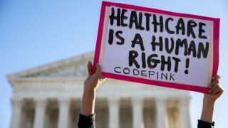 A demonstrator holds a sign outside the U.S. Supreme Court in Washington, D.C.