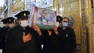 In this picture released by the Iranian Defense Ministry and taken on Saturday, Nov. 28, 2020, caretakers from the Imam Reza holy shrine, carry the flag draped coffin of Mohsen Fakhrizadeh, an Iranian scientist linked to the country's disbanded military nuclear program, who was killed on Friday, during a funeral ceremony in the northeastern city of Mashhad, Iran. An opinion piece published by a hard-line Iranian newspaper has suggested that Iran must attack the Israeli port city of Haifa if Israel carried out the killing of a scientist.