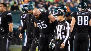Philadelphia Eagles offensive tackle Lane Johnson (65) is helped off the field after an injury during the second quarter against the New York Giants at Lincoln Financial Field.
