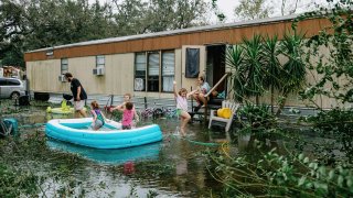 Clinton and Randal Ream with their son Saylor and daughter Nayvie and two neighbors Aubrey Miller and Harmony Morgan at their home in a small trailer park in West Pensacola. The area received a lot of damage after Hurricane Sally came through as a category 2 hurricane in Pensacola, La. on September 16th, 2020.