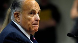 In this Dec. 2, 2020, file photo, Rudy Giuliani, personal lawyer of US President Donald Trump, looks on during an appearance before the Michigan House Oversight Committee in Lansing, Michigan.