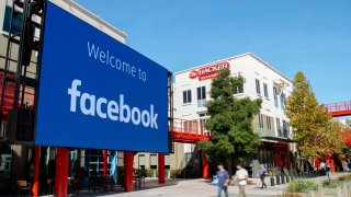 A giant digital sign is seen at Facebook’s corporate headquarters campus in Menlo Park, California, on October 23, 2019.
