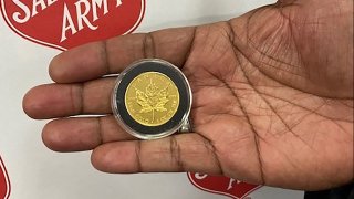 Salvation Army Capt. Anthony Barnes shows a 1-ounce gold coin found