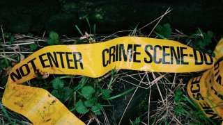 Crime Scene Tape Fallen On Grass