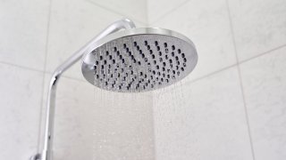 close up on head shower while running water