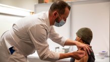 Jeff Doucette, Chief Nursing Officer at Jefferson Health, administers a Covid-19 vaccine to Mark Nicolas, a nurse at Jefferson Healths Cherry Hill campus, at Thomas Jefferson University Hospital in Philadelphia