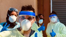 Tarik Khan, front, poses with colleagues donning personal protective equipment. They worked on the front lines in the coronavirus pandemic this year.