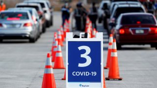 Florida Department of Health medical workers prepare to administer a COVID-19 vaccine to seniors in the parking lot of the Gulf View Square Mall in New Port Richey near Tampa, Florida, U.S. December 31, 2020.