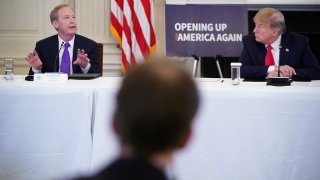 U.S. President Donald Trump listens to Microsoft President Brad Smith, left, speak during a roundtable discussion with industry executives on reopening the country, in the State Dining Room of the White House in Washington on May 29, 2020.