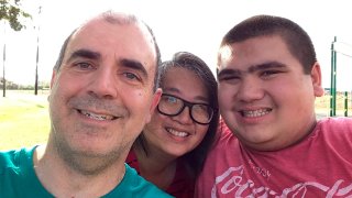 Donna Lou and Daren Parsa pose for a selfie with their son Eric, right.