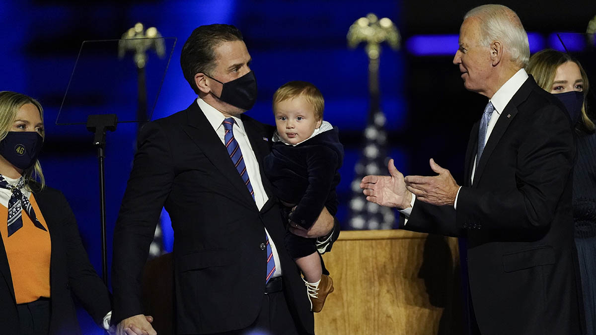 President-elect Joe Biden greets his son Hunter Biden and wife Melissa Cohen, left, as he holds his son, as he stands on stage with his family Saturday, Nov. 7, 2020, in Wilmington, Del. (AP Photo/Andrew Harnik)