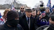 Roger Stone, former adviser to Donald Trump's presidential campaign, center, departs after speaking during a protest outside the Supreme Court in Washington, D.C., U.S., on Tuesday, Jan. 5, 2021. Republican lawmakers in Washington are fracturing over President Trump's futile effort to persuade Congress to overturn his re-election defeat, as his allies spar with conservatives who say the Constitution doesn't give them the power to override voters. Photographer: Stefani Reynolds/Bloomberg via Getty Images