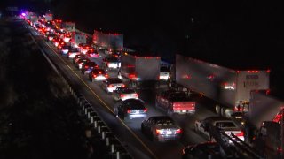 Cars line up bumper-to-bumper as police close a stretch of Interstate 95 in Northeast Philadelphia