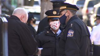 Three Philadelphia police officers stand near each other as they investigate the scene near where a 9-year-old girl accidentally shot herself to death.