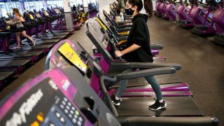 A person works out at Planet Fitness as they re-open at 25 percent capacity in Boston’s Dorchester on Feb. 1, 2021.