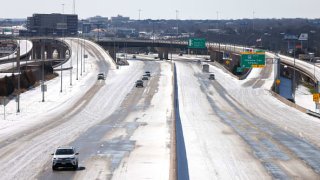Traffic moves along Interstate 30 after a snow storm Feb. 15, 2021 in Fort Worth, Texas.