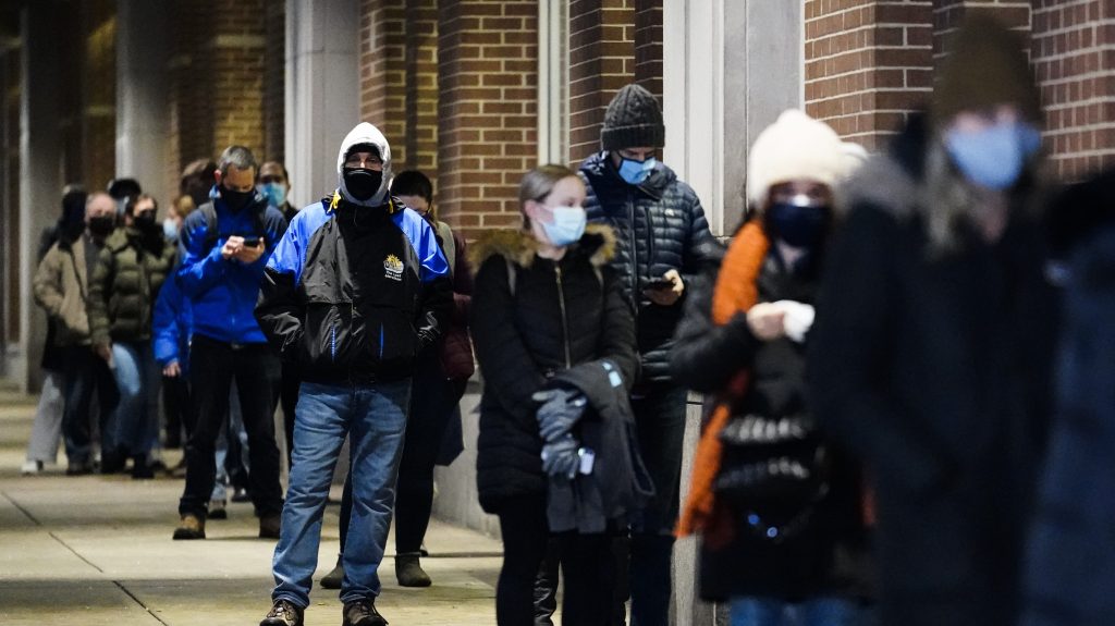 People wait in line at a COVID-19 vaccination site at the Pennsylvania Convention Center in Philadelphia, Wednesday, Feb. 3, 2021. The clinic opened to help provide second doses of COVID-19 vaccinations.