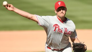 Jared Hughes throws a pitch in a Phillies uniform
