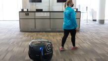 Photo courtesy of Philadelphia International Airport's gita robot and a woman