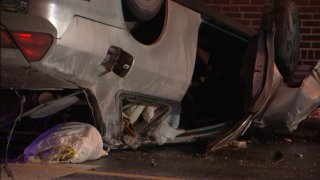 A silver car rests on its crushed roof after flipping over on an icy road in Philadelphia.