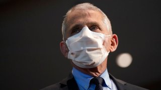 Dr. Anthony Fauci, director of the National Institute of Allergy and Infectious Diseases, speaks with Health and Human Services Secretary Alex Azar before receiving his first dose of the COVID-19 vaccine at the National Institutes of Health on Dec. 22, 2020 in Bethesda, Maryland.