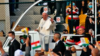 Pope Francis waves as he arrives for an open air Mass at a stadium in Irbil, Iraq