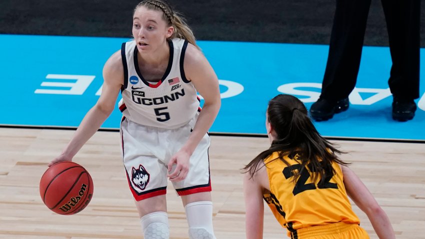 UConn guard Paige Bueckers (5) works the ball past Iowa guard Caitlin Clark (22) during the first half of a college basketball game in the Sweet Sixteen round of the women’s NCAA tournament at the Alamodome in San Antonio, Saturday, March 27, 2021. (AP Photo/Eric Gay)