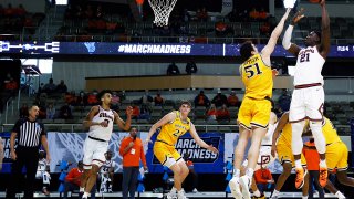 Kofi Cockburn #21 of the Illinois Fighting Illini attempts a shot while being guarded by James Butler #51 of the Drexel Dragons in the second half of the first round game of the 2021 NCAA Men's Basketball Tournament