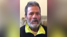 Roberto Oquendo Velez is seen in a black shirt with yellow collar