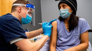 Woman is vaccinated with Pfzizer Covid-19 vaccine