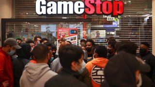 Shoppers wait for a GameStop store to open on at the Tysons Corner Center, in Tysons, Virginia, November 27, 2020.