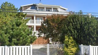 A large Ocean Drive beach house is seen behind shrubs in Rehoboth, Delaware