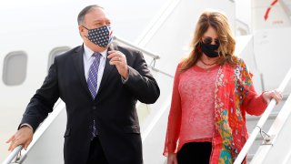 Secretary of State Mike Pompeo, and his wife Susan disembark from an aircraft upon their arrival at the airport in New Delhi, India, Monday, Oct. 26, 2020.