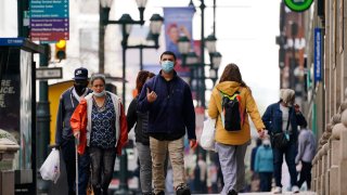 People walk along Market Street in Philadelphia, Wednesday, April 14, 2021. In Pennsylvania, redrawing the districts to correspond with population shifts identified by the 2020 census will have a particularly unpredictable effect on congressional districts, since the state is expected to lose a district.