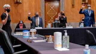 From left, Kiran Ahuja, the nominee to be Office of Personnel Management Director, and the nominees for Postal Service Governors Anton Hajjar, Amber McReynolds, and Ronald Stroman, are sworn in at a Senate Governmental Affairs Committee hybrid nominations hearing on Capitol Hill, Thursday, April 22, 2021, in Washington.