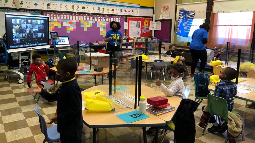 Children wearing masks inside a classroom