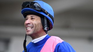 This photo provided by NYRA shows Kendrick Carmouche smiling in the paddock at Aqueduct Racetrack in the Queens borough of New York on Jan. 24, 2020. Carmouche is set to ride Bourbonic in the Kentucky Derby, the first Black jockey in the race since 2013.