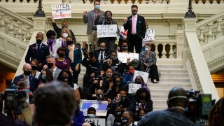 Demonstrators hold a sit-in inside of the Capitol building in opposition of House Bill 531 on March 8, 2021 in Atlanta, Georgia. HB531 will restrict early voting hours, remove drop boxes, and require the use of a government ID when voting by mail.