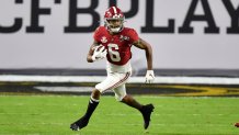 DeVonta Smith runs with a football