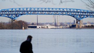 In this Wednesday, Feb. 24, 2021, file photo, person walks past the Interstate-95′s mile-long double-decked Girard Point Bridge in Philadelphia. Republicans in Pennsylvania’s Senate are trying to make Gov. Tom Wolf's administration start over on its plans to toll up to nine major bridges, approving a bill Tuesday, April 27, 2021, to require the state Department of Transportation to undergo a new process that includes approval from the Legislature.
