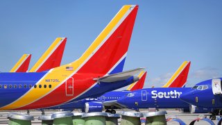 Southwest Airlines Boeing 737 MAX aircraft are parked on the tarmac after being grounded, at the Southern California Logistics Airport in Victorville, California on March 28, 2019.