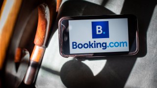 The Booking.com logo on a mobile phone.