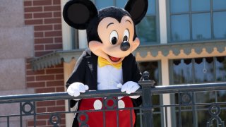 A performer dressed as Mickey Mouse entertains guests during the reopening of the Disneyland theme park in Anaheim, California, U.S., on Friday, April 30, 2021.